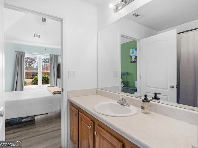 full bathroom featuring visible vents, wood finished floors, ensuite bath, and vanity