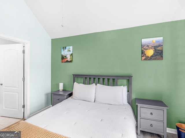 bedroom with lofted ceiling