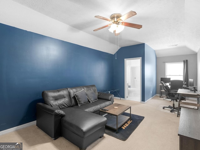 carpeted living room with a textured ceiling, a ceiling fan, baseboards, and vaulted ceiling