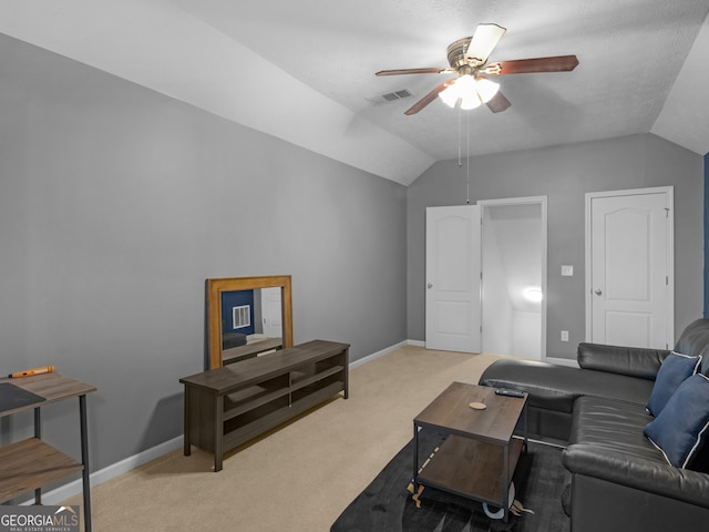 living area with visible vents, light colored carpet, and vaulted ceiling