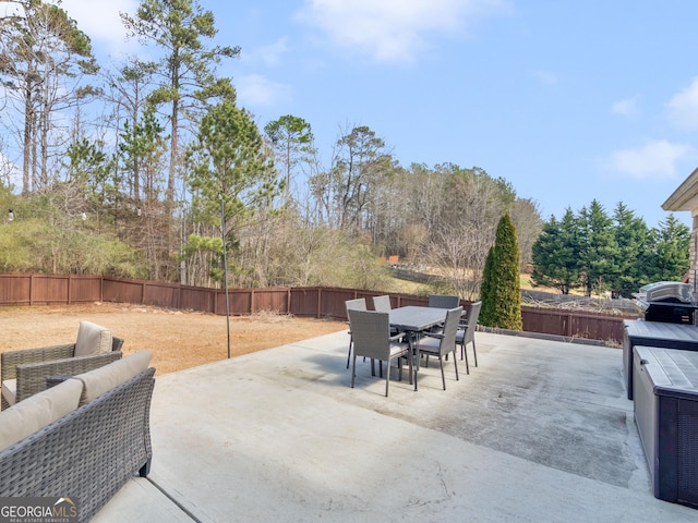 view of patio / terrace featuring outdoor dining space, a grill, and a fenced backyard