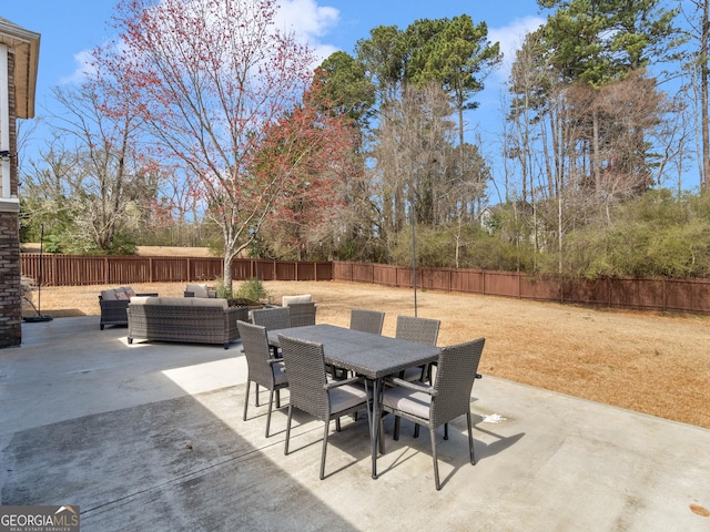 view of patio featuring outdoor dining space, an outdoor living space, and a fenced backyard