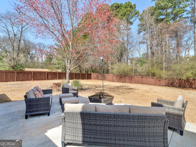 view of patio / terrace featuring an outdoor living space with a fire pit and a fenced backyard