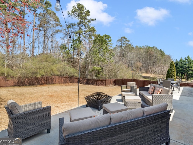 view of patio featuring an outdoor living space with a fire pit and a fenced backyard