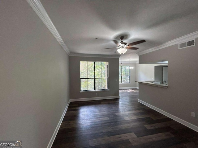 unfurnished living room with visible vents, crown molding, baseboards, and dark wood-style flooring