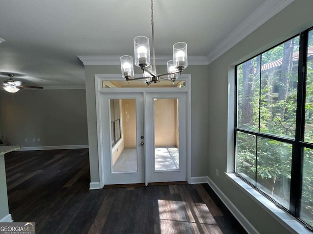 unfurnished dining area with dark wood finished floors, french doors, crown molding, and baseboards