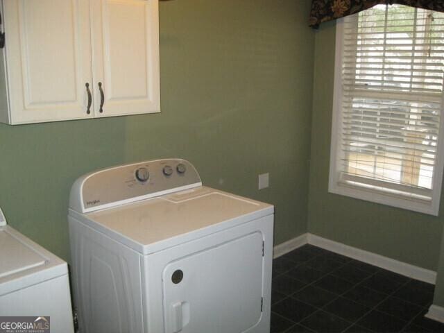 103 Twilight Ct, Jackson, GA 30233 - laundry room with baseboards, cabinet space, dark tile patterned flooring, and washing machine and clothes dryer