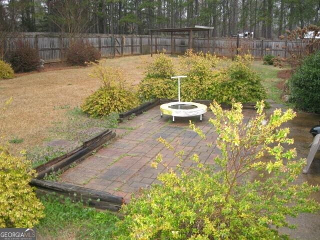 103 Twilight Ct, Jackson, GA 30233 - fenced backyard featuring a patio and an outdoor fire pit