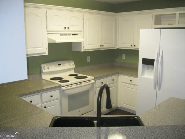 103 Twilight Ct, Jackson, GA 30233 - kitchen with under cabinet range hood, white appliances, white cabinetry, and a sink