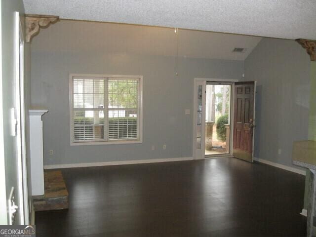 103 Twilight Ct, Jackson, GA 30233 - interior space featuring baseboards, a textured ceiling, wood finished floors, and vaulted ceiling