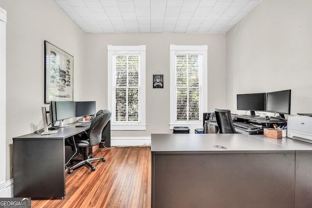 office space featuring baseboards and wood finished floors