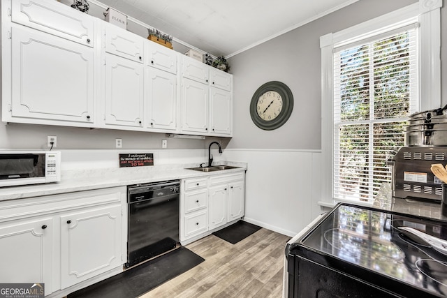 kitchen with white microwave, a sink, ornamental molding, white cabinets, and dishwasher