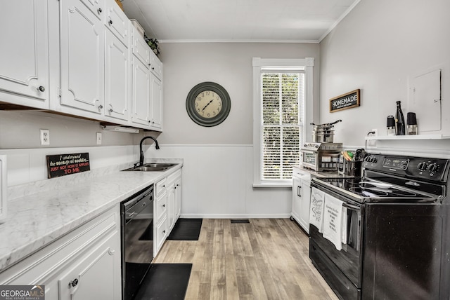 kitchen featuring a sink, light wood-style floors, black appliances, and white cabinetry