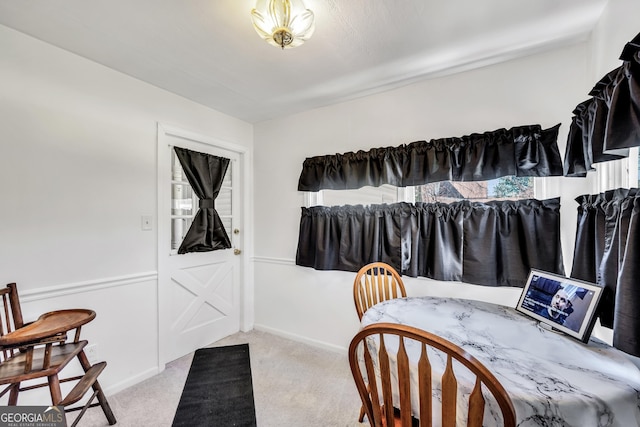 interior space with carpet and baseboards