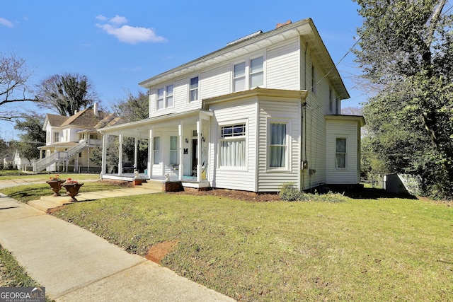 view of front of house featuring covered porch and a front yard