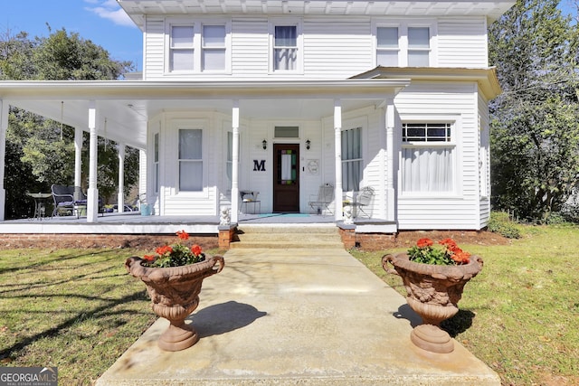 view of front of home featuring covered porch and a front lawn