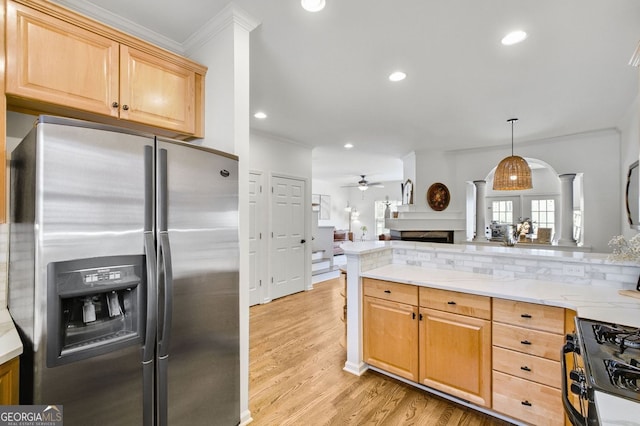 kitchen with light brown cabinetry, open floor plan, black gas stove, and stainless steel fridge with ice dispenser