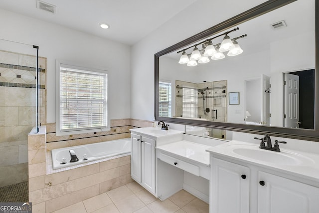 full bath with a bath, visible vents, a shower stall, and a sink