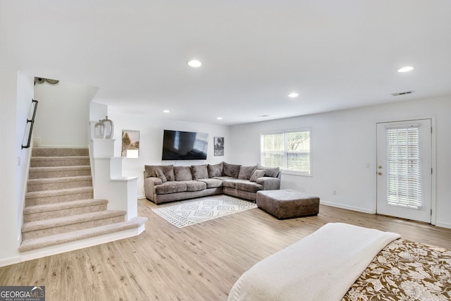 living area featuring stairway, wood finished floors, visible vents, baseboards, and recessed lighting