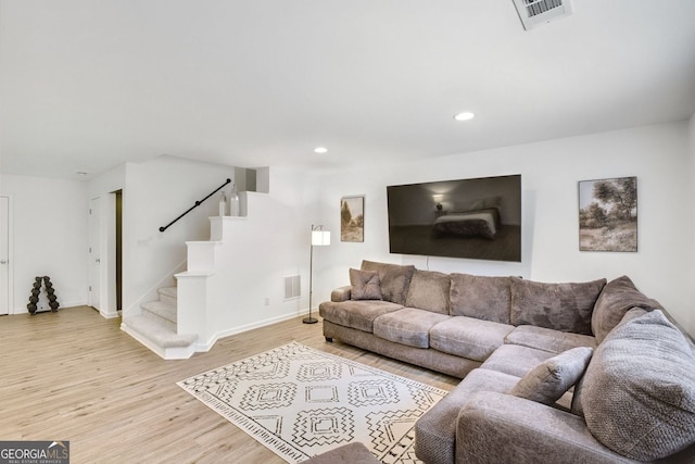 living area featuring stairway, recessed lighting, light wood-style floors, and visible vents