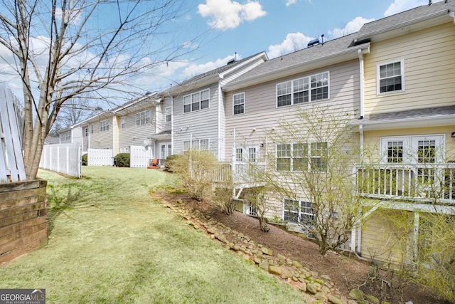 exterior space featuring fence and a lawn