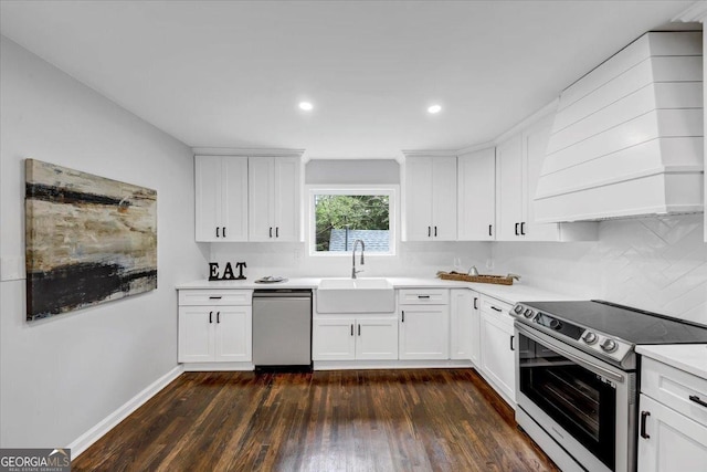 kitchen featuring dark wood-style floors, a sink, light countertops, appliances with stainless steel finishes, and white cabinetry