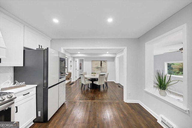 kitchen featuring visible vents, electric range, white cabinetry, freestanding refrigerator, and dark wood-style flooring