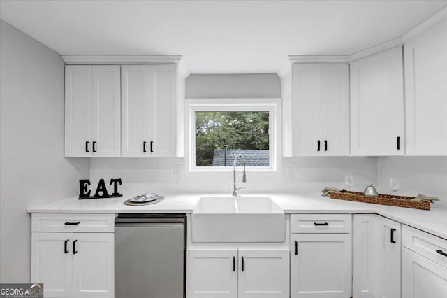 kitchen featuring white cabinets, light countertops, and a sink