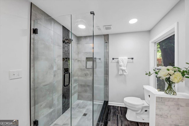 bathroom featuring visible vents, toilet, a stall shower, recessed lighting, and baseboards