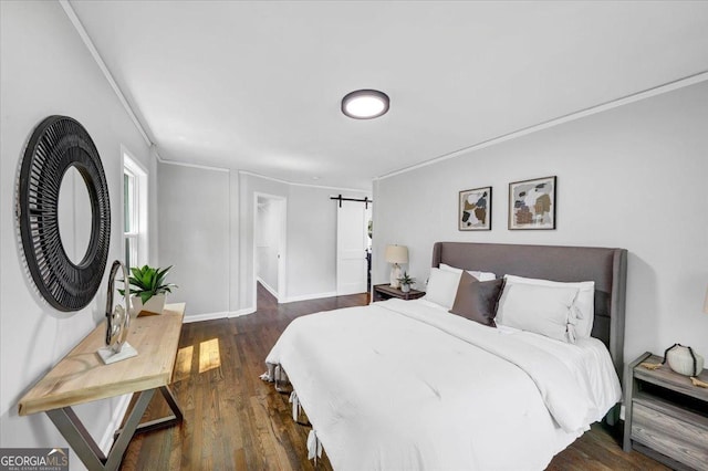 bedroom featuring a barn door, baseboards, dark wood-style floors, and crown molding