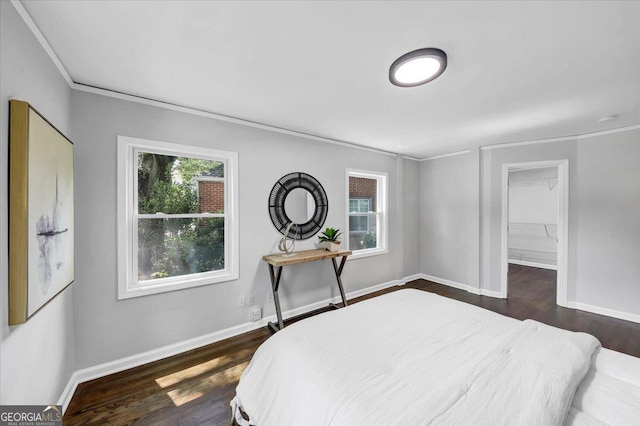 bedroom featuring baseboards, dark wood-type flooring, and crown molding