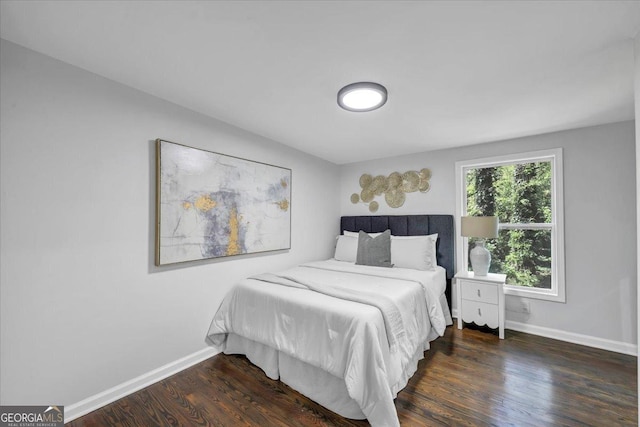 bedroom featuring baseboards and wood finished floors