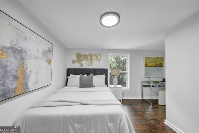 bedroom featuring baseboards and wood finished floors