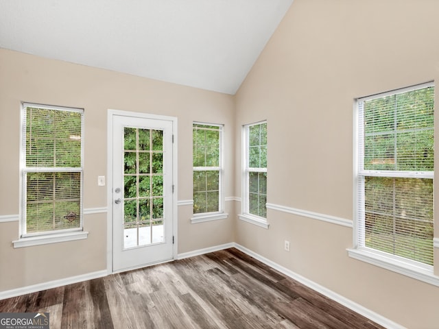 doorway to outside featuring vaulted ceiling, wood finished floors, and baseboards