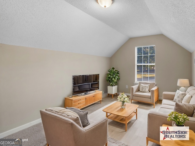 living room with vaulted ceiling, light carpet, baseboards, and a textured ceiling