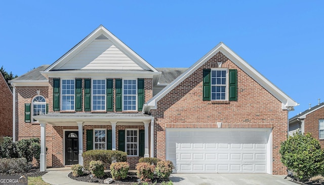 traditional-style home featuring brick siding, a porch, and concrete driveway