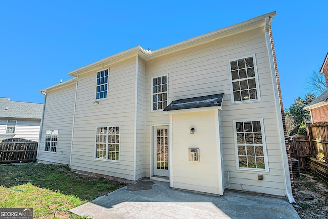 rear view of property with a patio area and fence