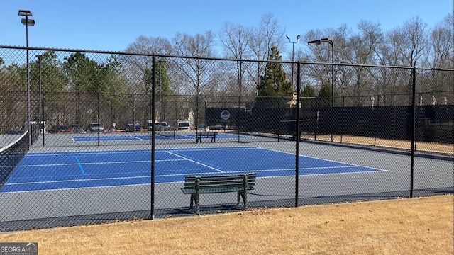 view of tennis court featuring fence