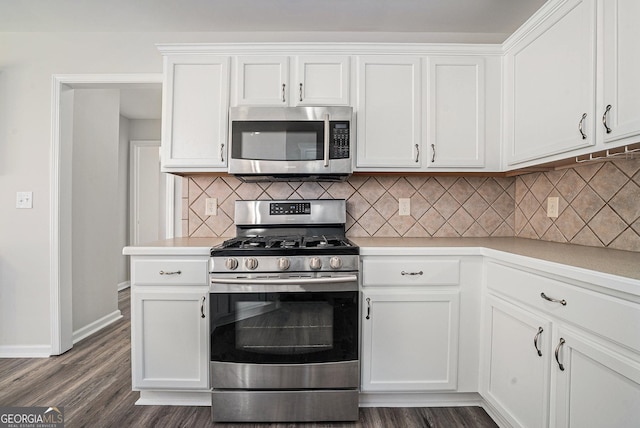 kitchen with stainless steel appliances, dark wood-style floors, and light countertops