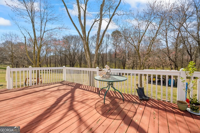 wooden terrace with a lawn