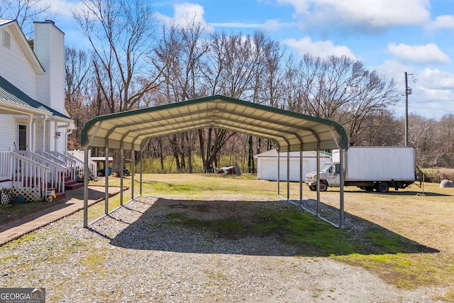 view of parking / parking lot with a detached carport and driveway