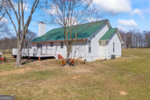 rear view of property featuring a yard, central AC, a chimney, crawl space, and a deck