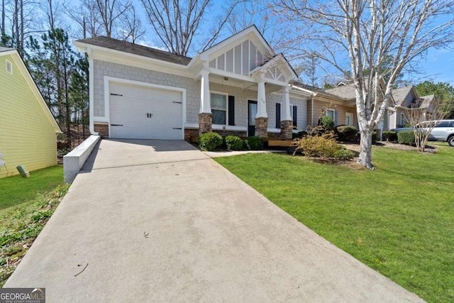 craftsman-style house with stone siding, a porch, concrete driveway, a front yard, and a garage