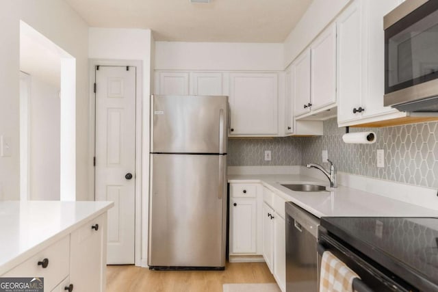 3529 Essex Ave Unit 75, Atlanta, GA 30339 - kitchen featuring a sink, stainless steel appliances, white cabinetry, and light countertops