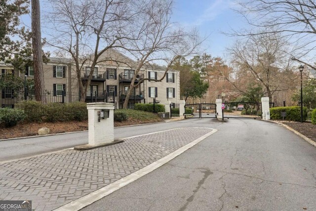 3529 Essex Ave Unit 75, Atlanta, GA 30339 - view of road featuring a gated entry, curbs, street lighting, and a gate