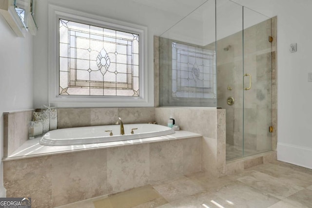 full bathroom featuring a shower stall and a garden tub