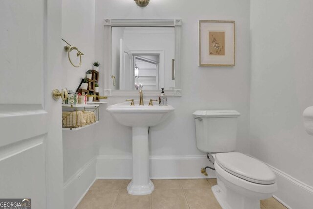 bathroom with toilet and tile patterned flooring