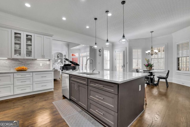 kitchen featuring stainless steel dishwasher, dark wood-style floors, white cabinetry, and a sink