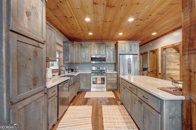 kitchen with wood ceiling, recessed lighting, gray cabinets, stainless steel appliances, and a sink