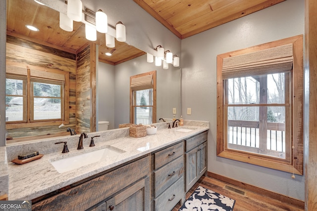 full bathroom featuring wooden ceiling, visible vents, and a sink